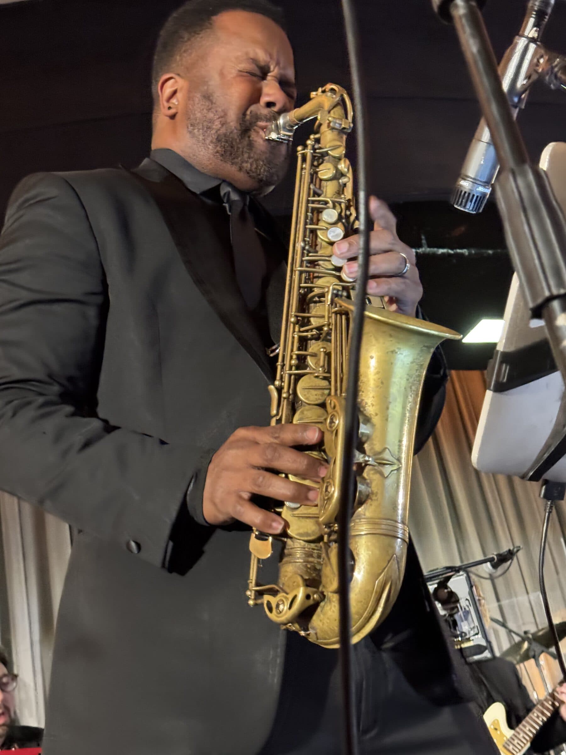 A saxophonist taking a solo in front of the band