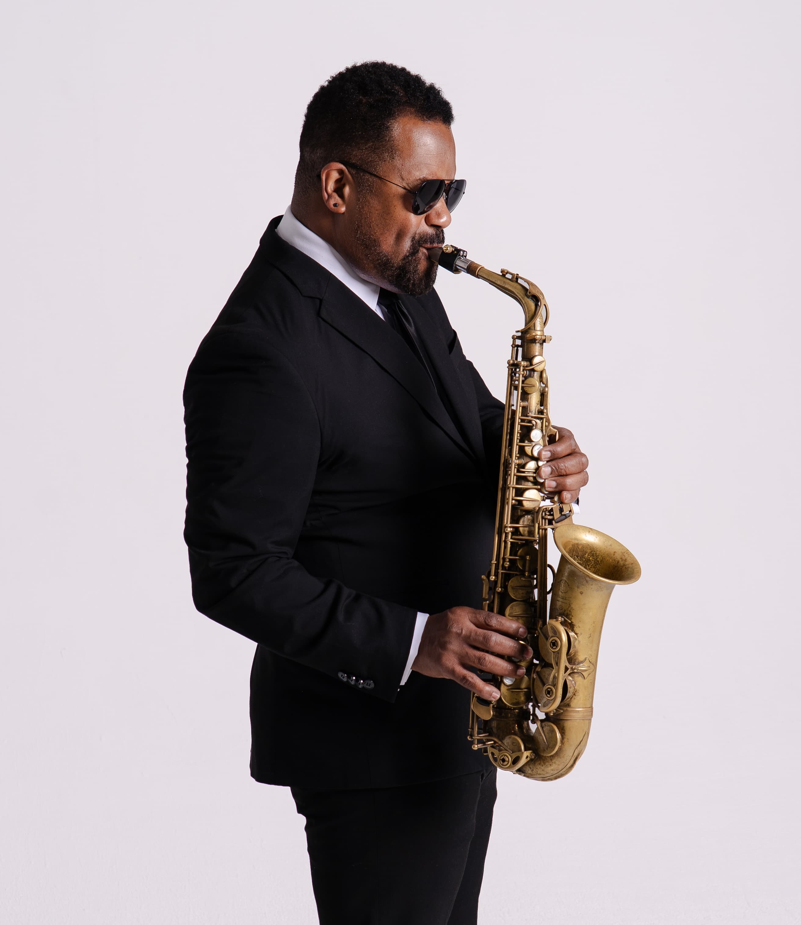 Andre playing sax - sideways with shades
